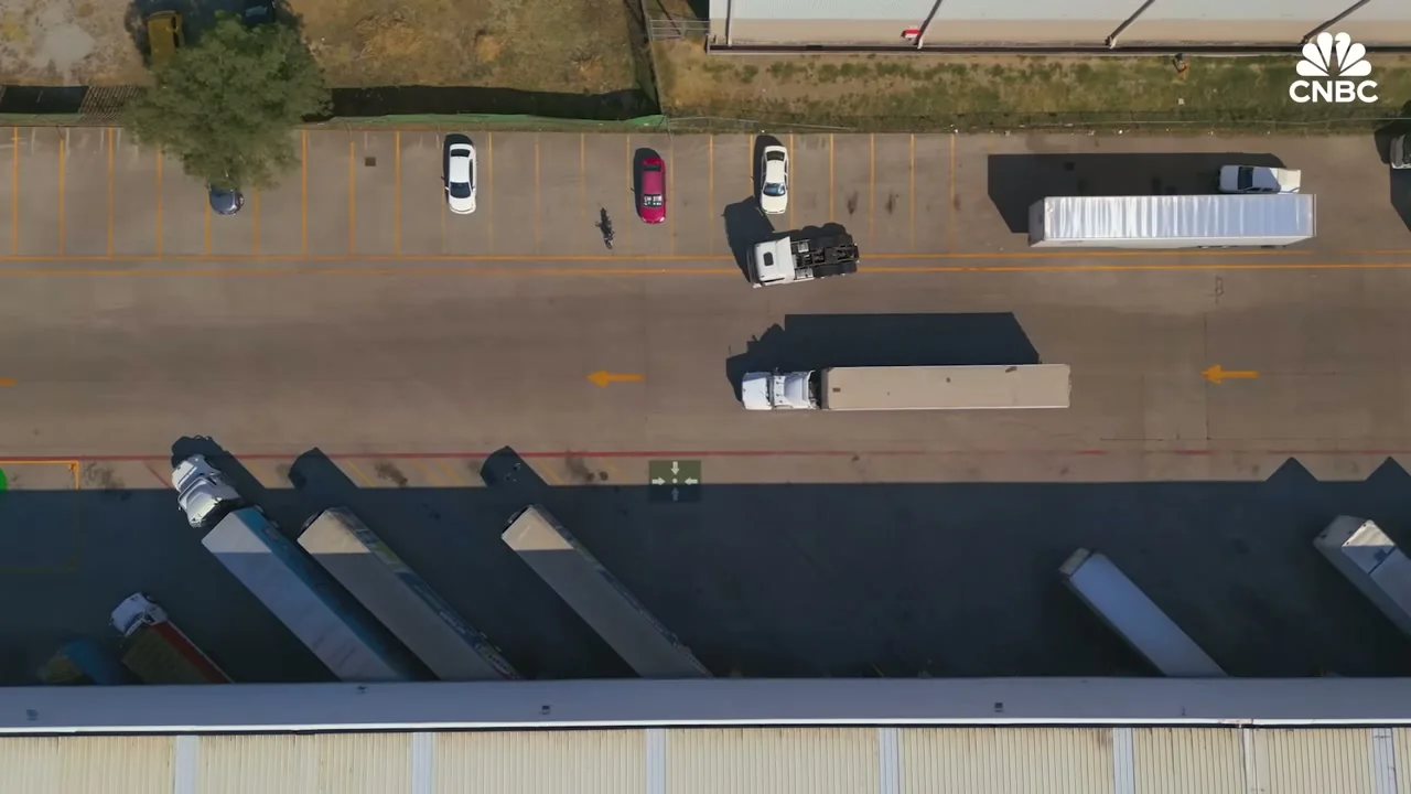 Logistics yard showing Chinese EV vehicles and shipping activity in Mexico
