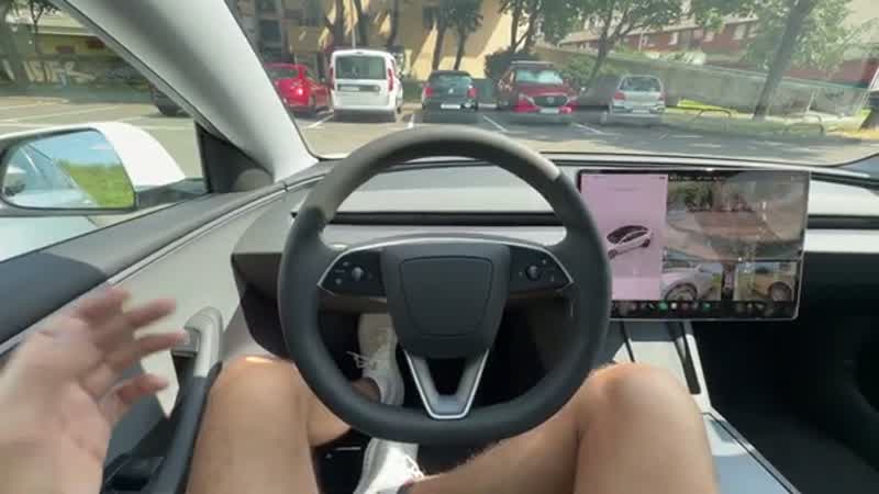 Model 3 positioning between two parked cars during Autopark
