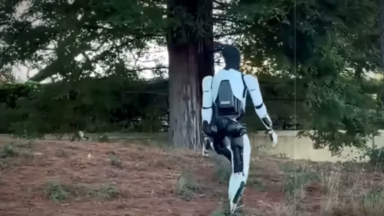 Tesla Optimus humanoid robot walking outdoors — the centerpiece of Tesla's post-car pivot and 2026 capex plan