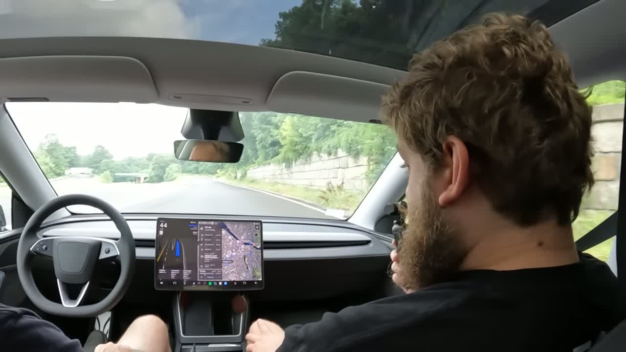 Tesla Model Y driving hands-free on a US road, illustrating FSD supervised autonomy
